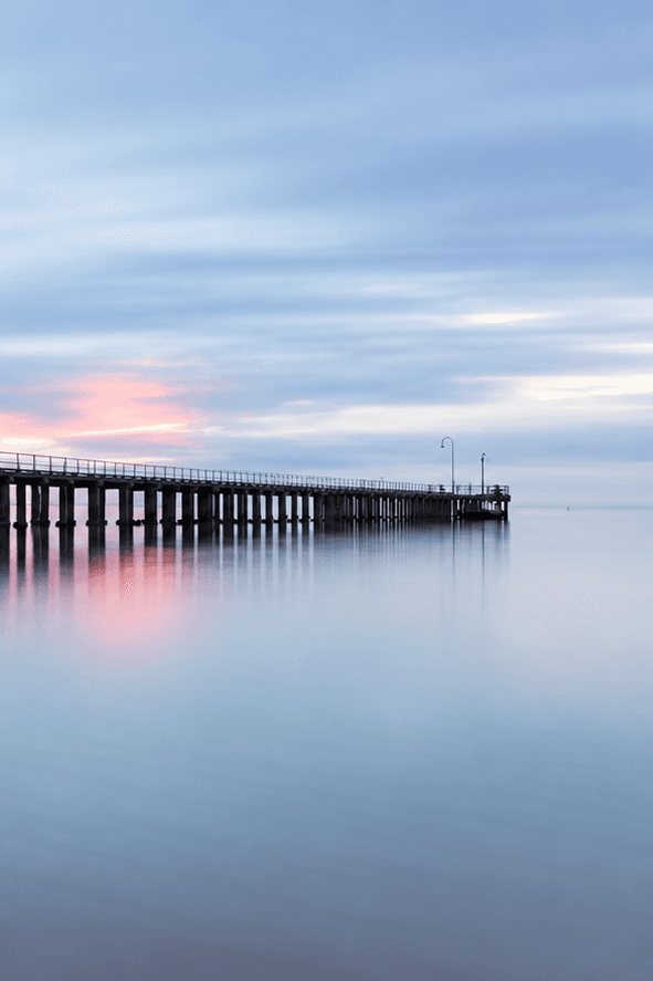 A quiet open horizon where pale sea meets a softly lit sky